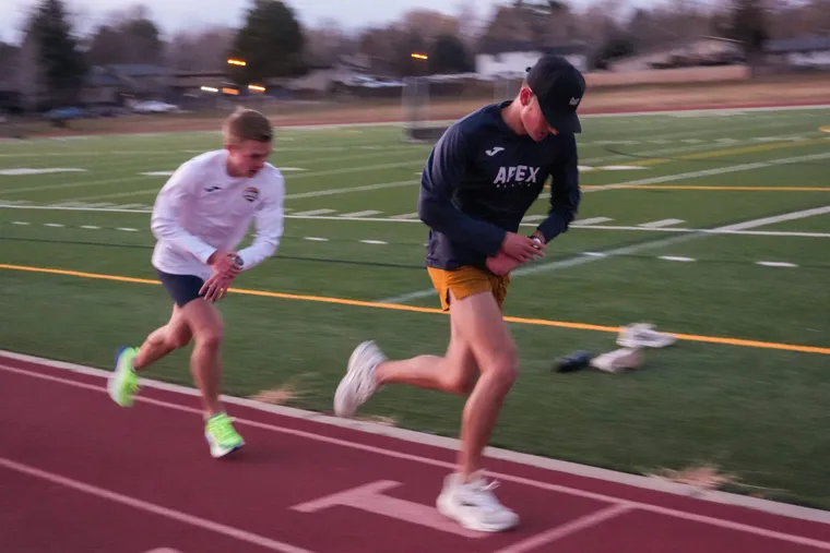 Two Apex Elite athletes starting a workout rep on the track