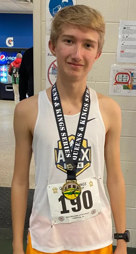 Apex Elite youth athlete wearing a medal after an indoor track race
